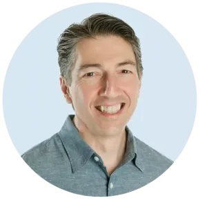 Photo of mediator Joe Dillon at the center of the Equitable Mediation team, all smiling and poised around a conference table ready to assist. Looking for expert, compassionate divorce support? Call Equitable Mediation at (877) 732-6682 to connect with our dedicated team today.